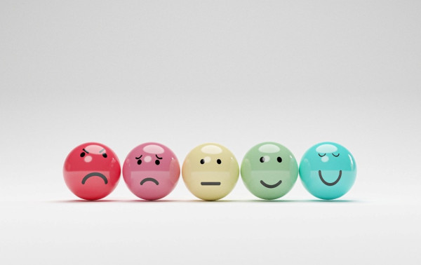 different coloured balls with different facial expressions